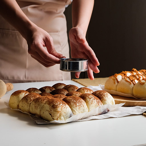 Baker making rolls